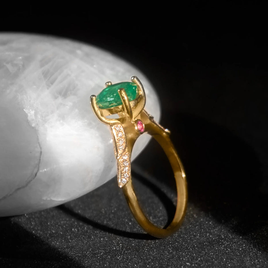 Gold ring with green emerald and diamonds on black background, Eclat d'or jewelry