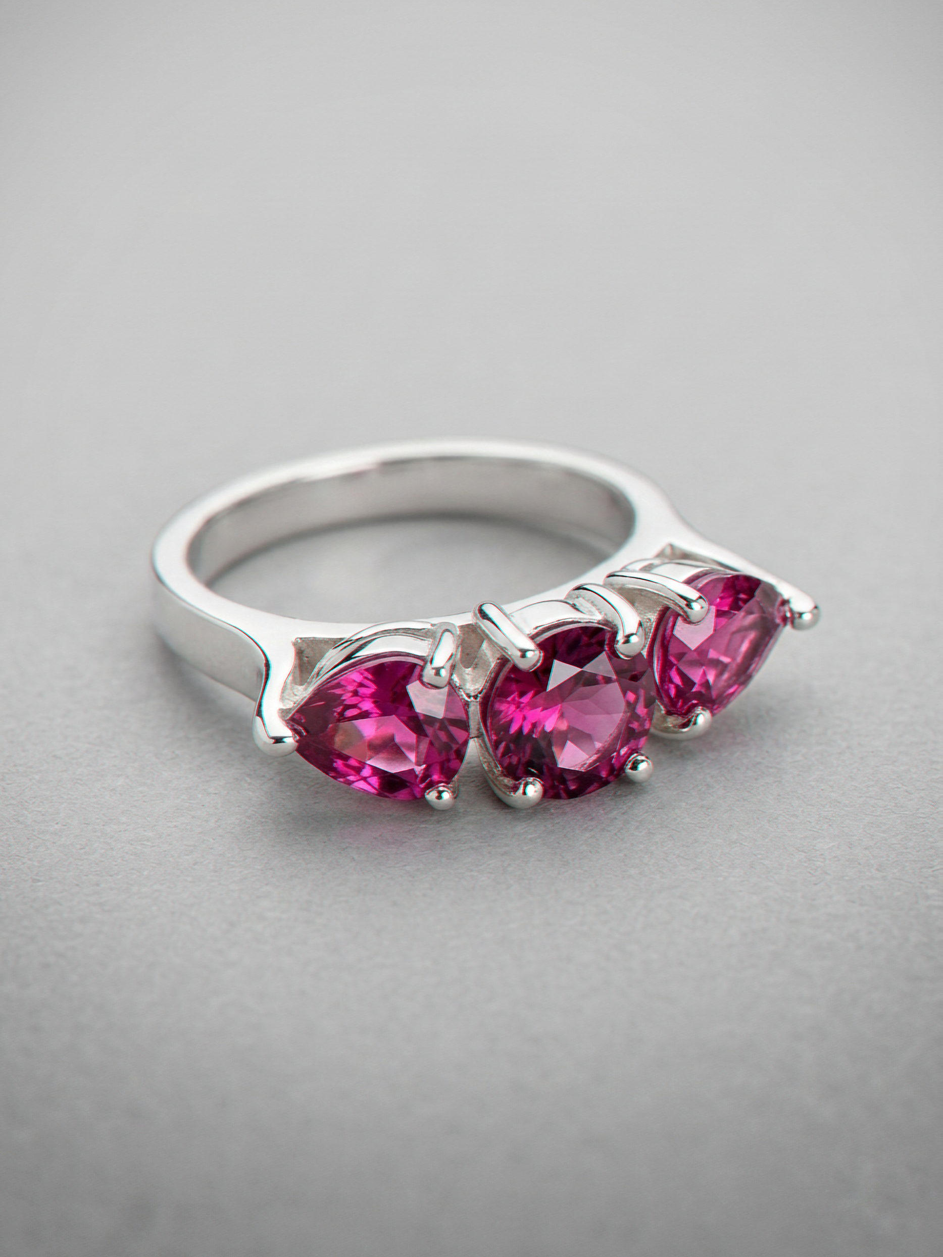 Bague en argent Eclat d'or avec pierre de grenat rouge, fine et élégante, vue en gros plan sur le doigt.